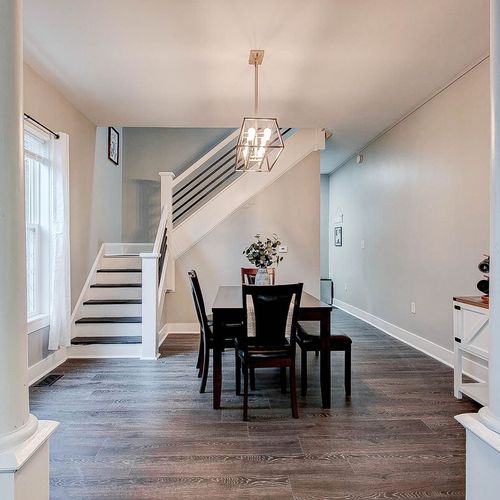 Stairs up to the bedroom on the left, coffee bar on the right and large dining table to enjoy your evenings with your company.