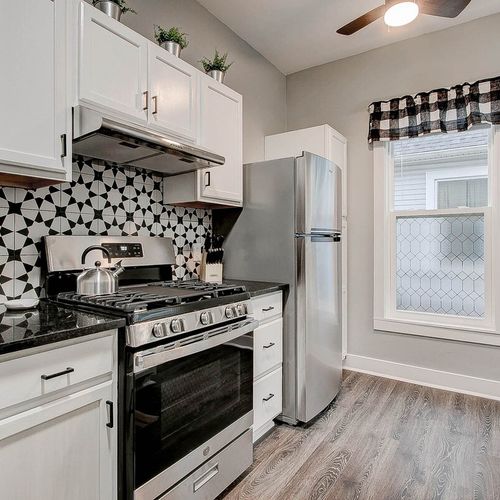Beautiful farmhouse style kitchen with all of the essentials; cooking utensils, oil, salt and pepper, etc.