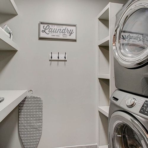 Laundry room with washer and dryer, ironing/folding station and provided detergent and softener for your convenience!