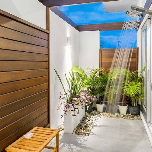 Both rooms have a large outdoor shower