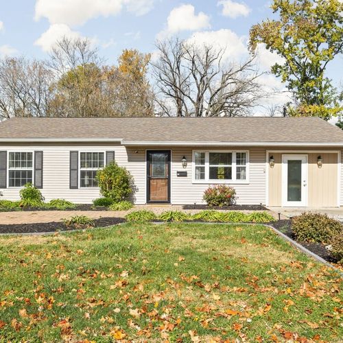 Charming Exterior: Enjoy the welcoming curb appeal surrounded by colorful gardens and lovely trees!