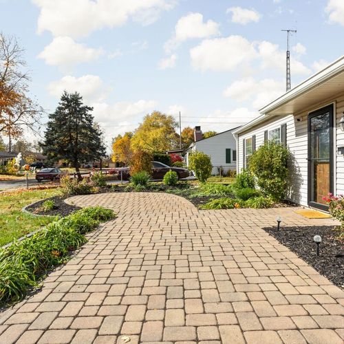 Exterior: Experience charming curb appeal with landscaped gardens and warm sunlight illuminating the path!