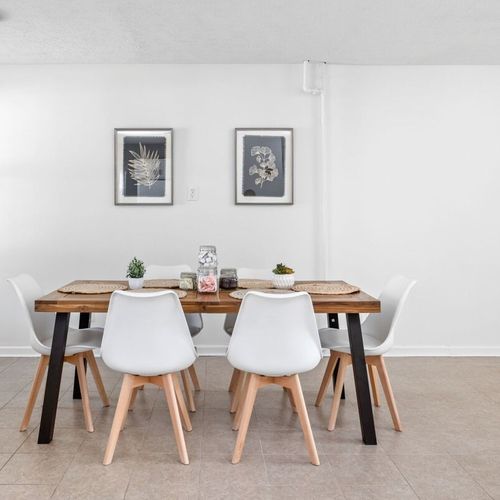 An elegant six-seater dining table, perfectly complementing the overall elegance of this dining space.