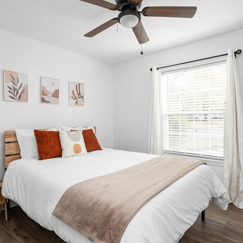 Bedroom: Bright and airy space with a queen bed, modern decor, and natural light streaming in!