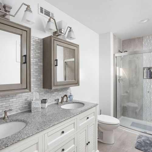 Master Bathroom: Enjoy sleek design with dual vanities, elegant fixtures, and a luxurious shower!
