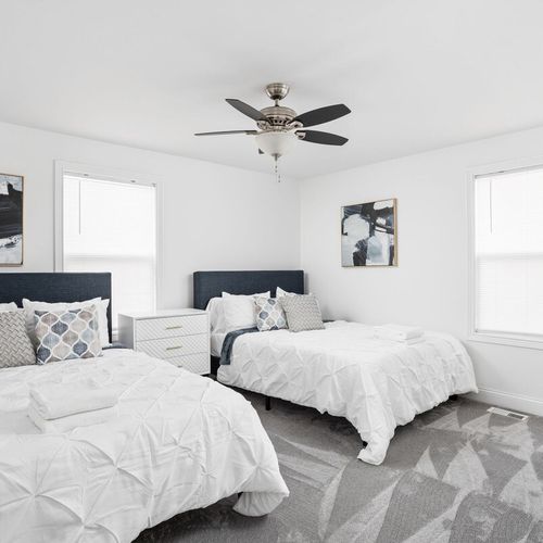 Inviting Bedroom: Bright and airy retreat featuring two queen beds and elegant decor!