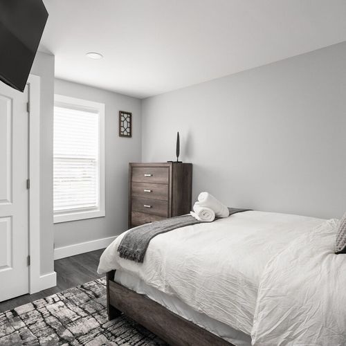 Bedroom: Modern retreat with a queen bed, bright windows, and chic decor for perfect relaxation.
