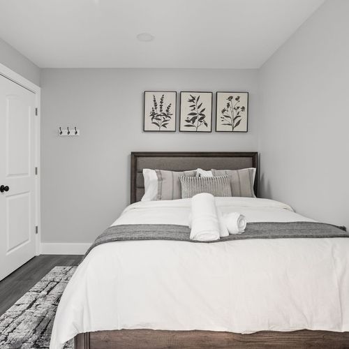 Bedroom: Serene space with botanical art, plush bedding, and modern amenities for restful nights!