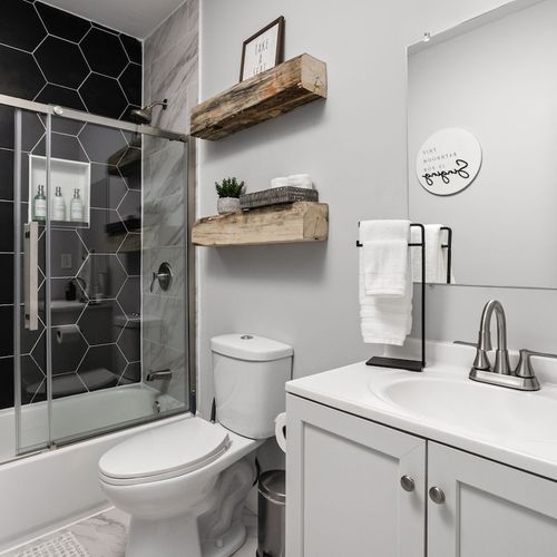 Bathroom 2: Modern elegance with hexagon tiles and essential amenities for your vibrant getaway!