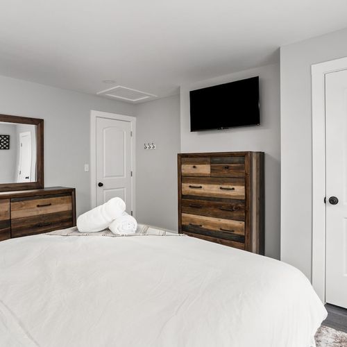 Bedroom Retreat: Bright space with plush bedding, decorative accents, and modern amenities await!