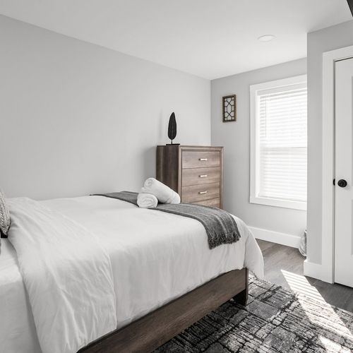 Bedroom: Serene space with botanical art, plush bedding, and modern amenities for restful nights!