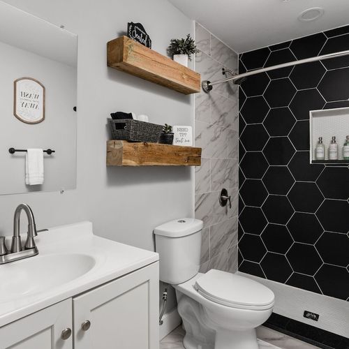 Bathroom 1: Enjoy stylish hexagon tiles and modern finishes for your ultimate relaxation retreat!