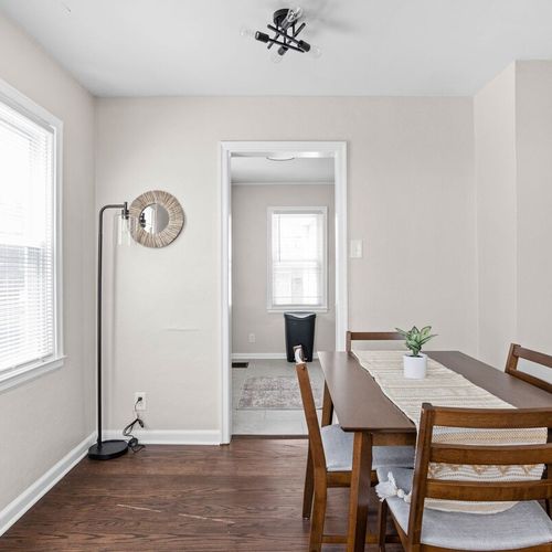 A cozy dining area with a four-seating table, providing a perfect spot for shared meals and conversations.