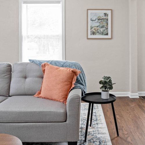 Experience the luxurious comfort of our strikingly soft sofa, complemented by elegantly decorated walls and a window offering a natural view from within.