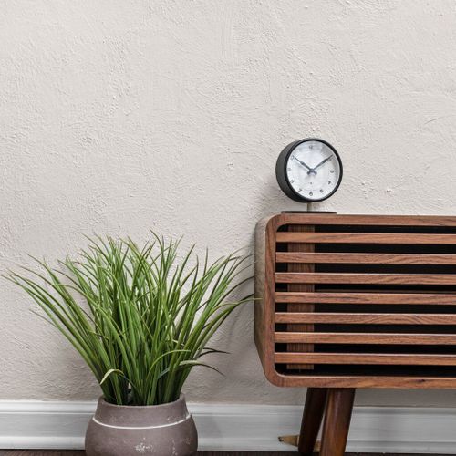 A delightful touch of nature with a flower and a functional clock embellishes the space.