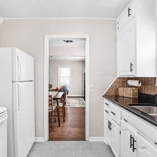 Experience the striking elegance of our kitchen, gleaming with cleanliness and equipped with modern appliances, cooking essentials, and utensils.