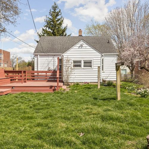 Fenced backyard with a refreshing porch, providing a tranquil and private outdoor space.