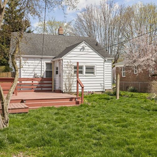 Fenced backyard with a refreshing porch, providing a tranquil and private outdoor space.
