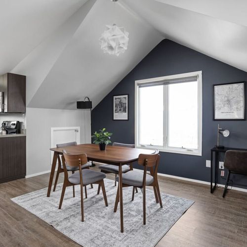 Discover our dining area, featuring a four-seating table, a window, and on the other side, a functional working table, creating a versatile and well-lit space.