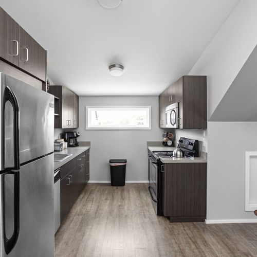 Experience our gleaming, clean kitchen, fully equipped with cooking essentials, utensils, and modern appliances for your culinary needs.