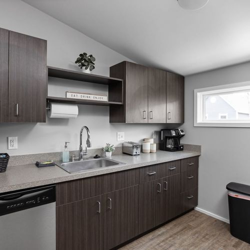 Experience our gleaming, clean kitchen, fully equipped with cooking essentials, utensils, and modern appliances for your culinary needs.