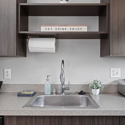 Take in the brilliance of our sparkling kitchen sink, embellished with new kitchen towels, sponges, and hand soap for your ease.