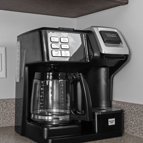 Indulge in a freshly brewed cup of coffee with the coffee maker provided for your convenience.
