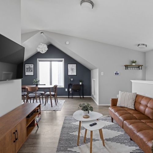 Inviting living area, complete with a TV for entertainment, a soft sofa, and a coffee table, creating a comfortable and leisurely space.