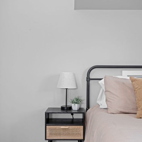 Beside the bed, you'll find a convenient bedside table adorned with a lamp for a cozy and well-lit corner.