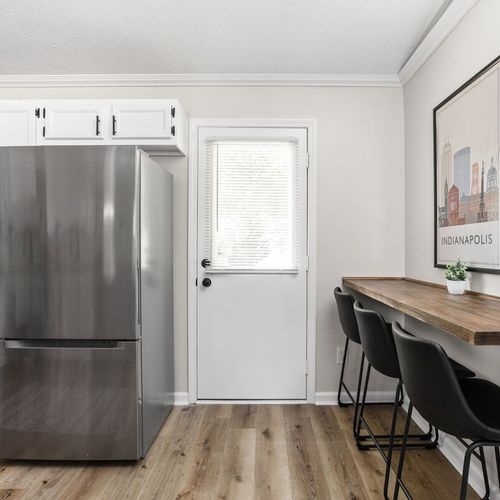 Refregerator, and adjacent to it is a three-seater spot for dining.