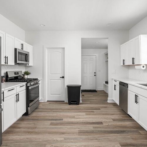 A well-appointed kitchen with a sophisticated modern design that seamlessly blends style and functionality.