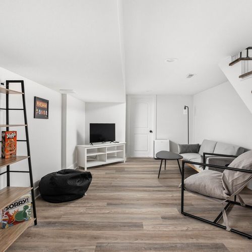 Another charming unwinding area adorned with a bookshelf and TV – a perfect blend of relaxation and entertainment for your enjoyment.