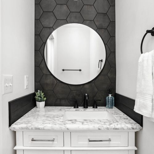 The elegance of our bathroom, complete with a stylish sink and a sophisticated bathroom vanity dresser for a touch of luxury and functionality.