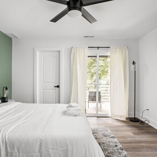 Cozy ambiance of the bedroom, complete with a TV and a window allowing natural light to fill the room, creating a perfect retreat for relaxation.