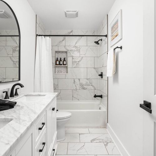 A complete bathroom experience with bath towels, shampoo, conditioner, body wash, and all the essential amenities for your convenience and comfort.