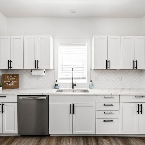 stylish cabinets, a sleek sink, and a convenient dishwasher for a seamless and sophisticated culinary experience.