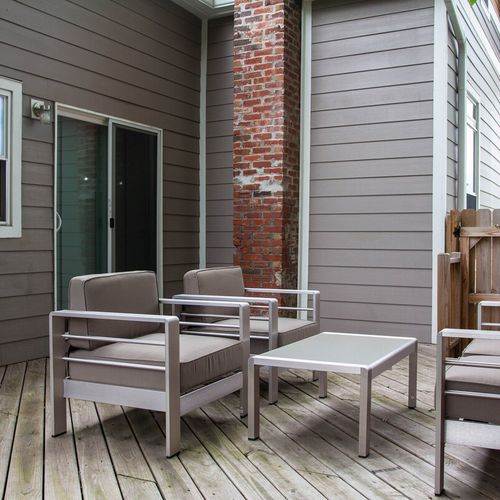 Picture a cozy scene on the porch with a coffee table surrounded by four comfortable chairs, inviting you to unwind and enjoy the outdoor ambiance.