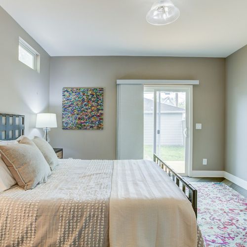 The cozy ambiance of our bedroom, perfect for delightful nights of restful sleep. Fresh linens, snug pillows, and a bedside table with a lamp complemented by a window for a natural view outside create a tranquil retreat.