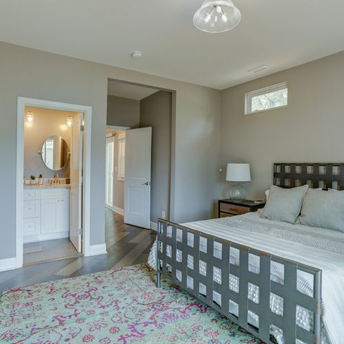 Embrace the cozy atmosphere of our bedroom, thoughtfully designed for delightful nights of restful sleep. Enjoy fresh linens, snug pillows, a bedside table with a lamp, and the added convenience of an attached, strikingly designed bathroom for a truly serene experience.
