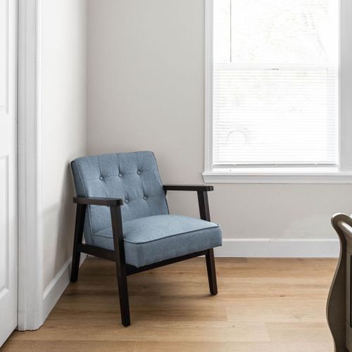 An additional cozy seat placed near the window in your room. Enjoy a relaxing spot with a view!