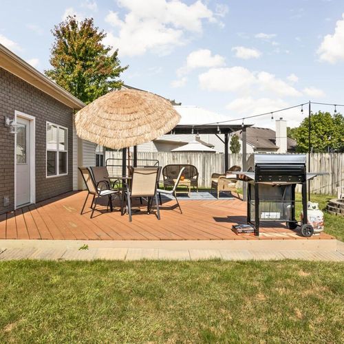 Step outside to the charm of an outdoor dining table and grill, offering the perfect setting for delightful meals and barbecue gatherings.