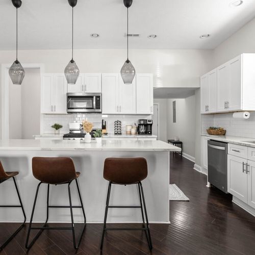 Our inviting kitchen, designed with a spacious countertop for both food preparation and dining. Perfect for hosting those family dinners!