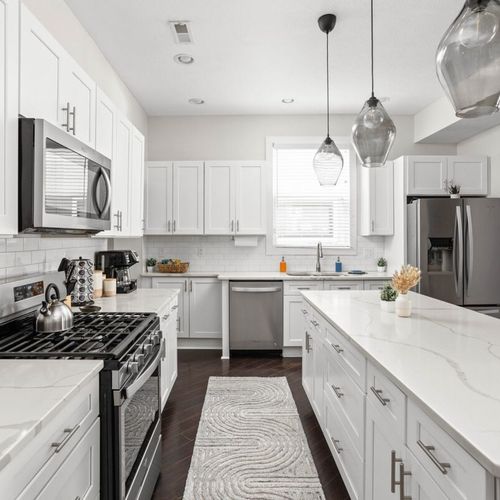 Step into our elegant, pristine kitchen, complete with a range of cooking utensils, modern appliances, and all the essentials you need for a seamless culinary experience.