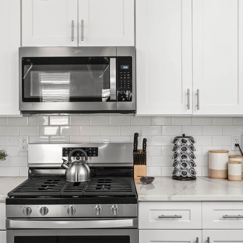 Discover the heart of our kitchen, equipped with a stove, oven, microwave, and coffee maker, ensuring you have all the tools needed to create delightful meals and enjoy your favorite beverages.