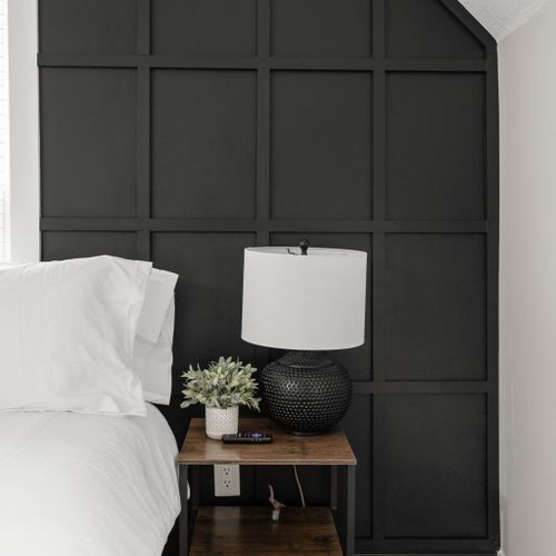 Discover a bedside table for your cute belongings, accompanied by a warm lamp, enhancing the coziness for a more comfortable stay.