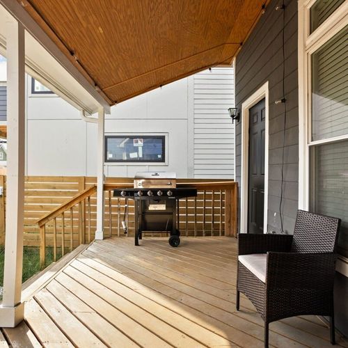 Relax on the backyard porch, complete with comfortable chairs—a perfect spot to unwind and take in the surroundings.