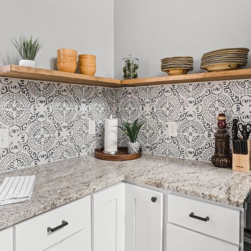 Fully equipped kitchen, complete with essentials such as a knife set, stove, plates, and neatly organized kitchen cabinets