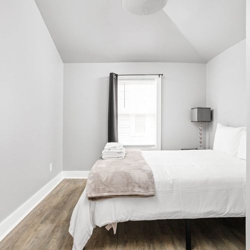 Relax in a cozy bed with soft pillows, complemented by the luxury of fresh, clean towels for your comfort.