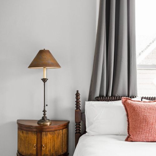 Bedside table and lamp, adding a touch of warmth and functionality to your sleep space.
