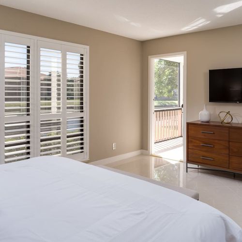 Master bedroom features a king size bed, incredible water and golf course views, access to the balcony and a smart tv.